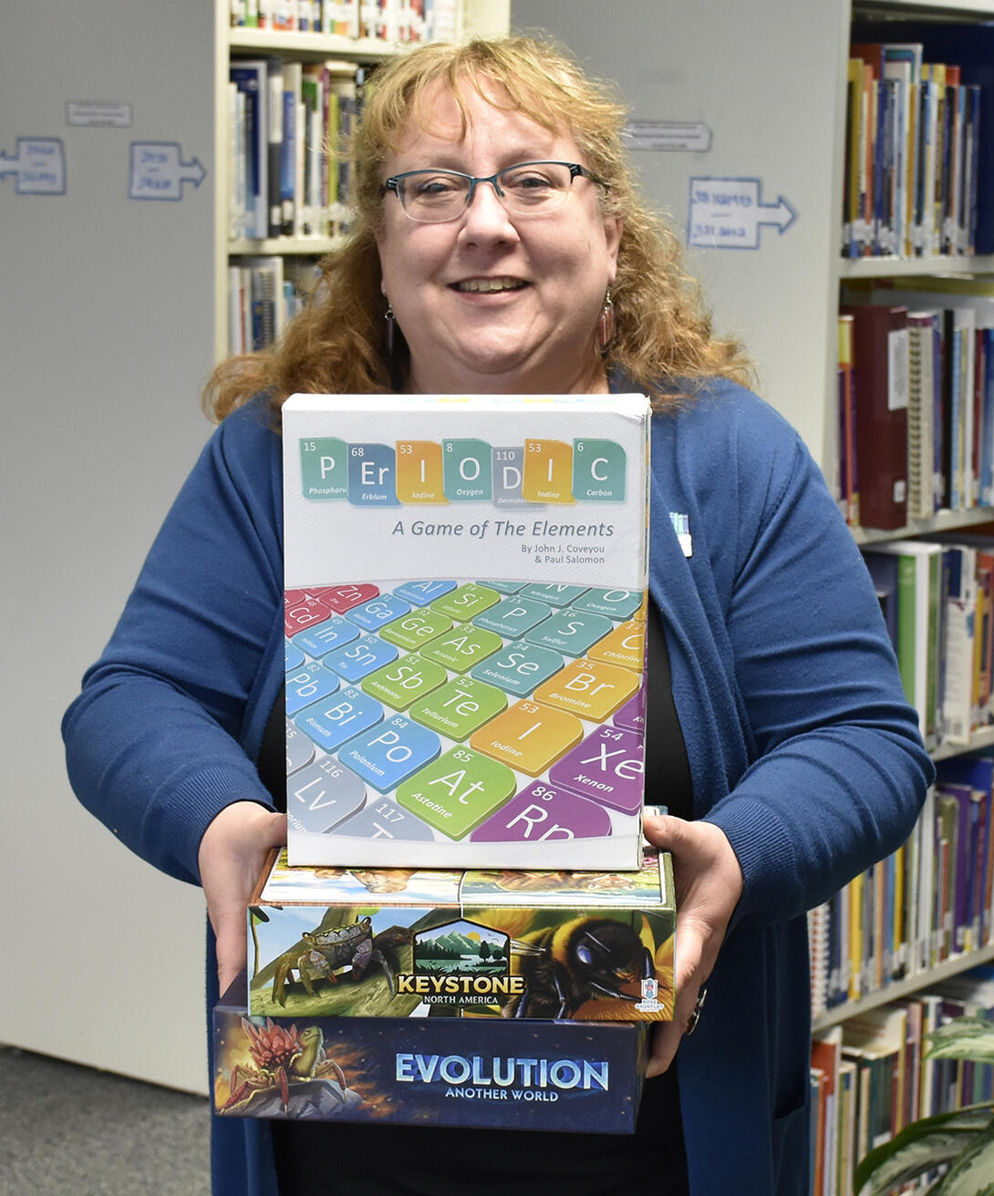 ATA librarian holds a selection of classroom games